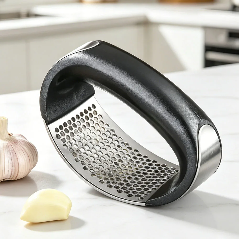 Rocking motion demonstration of ring-lever garlic press over unpeeled garlic clove